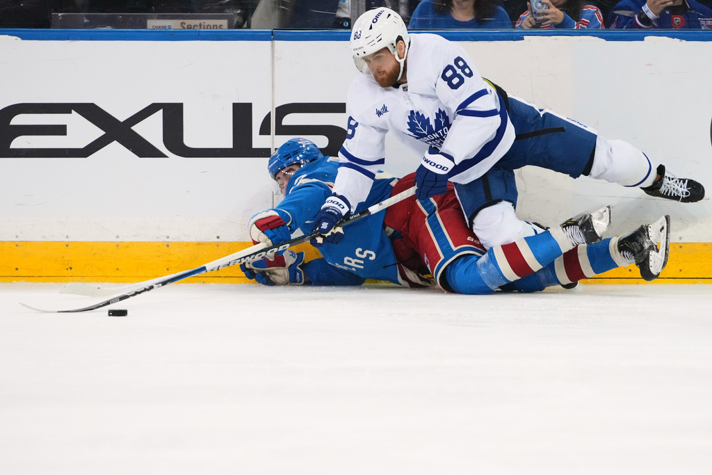 Toronto Maple Leafs' William Nylander (88) fights for control of the puck with New York Rangers' Mika Zibanejad during the second period of an NHL hockey game Thursday, March 5, 2026, in New York. (AP Photo/Frank Franklin II)
