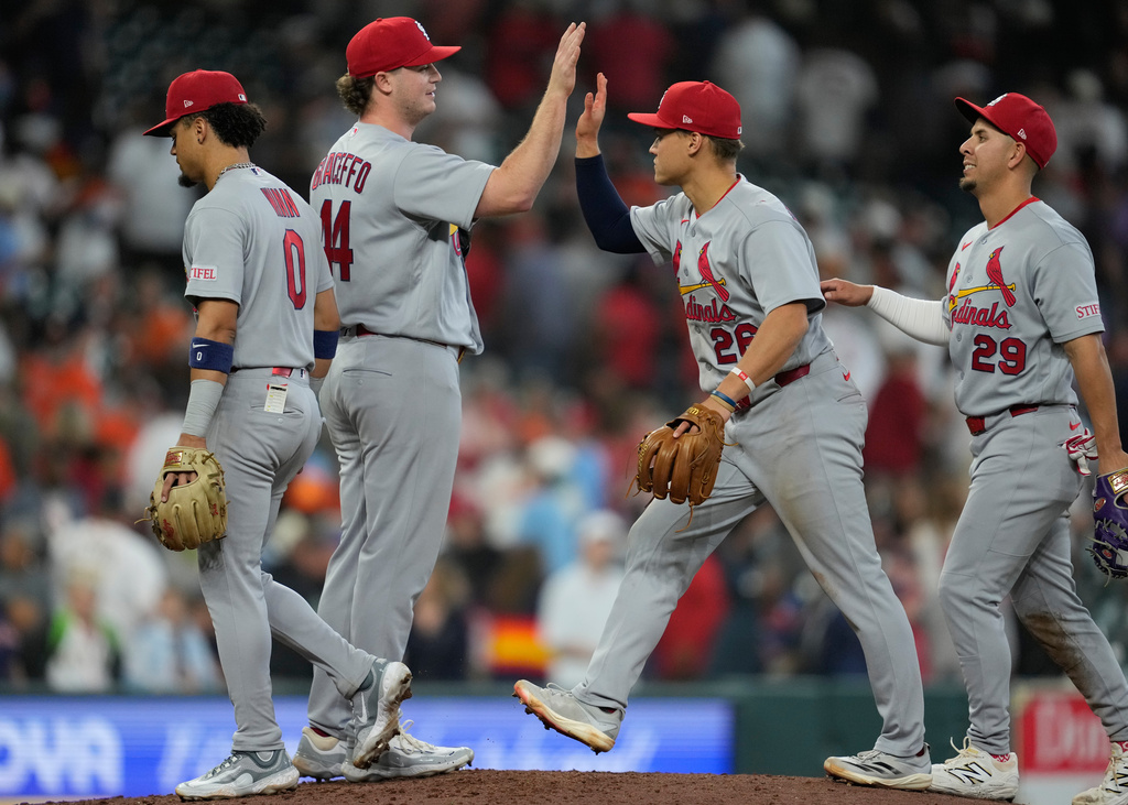 St. Louis Cardinals pitcher Gordon Graceffo (44) celebrates with shortstop Masyn Winn (0), second baseman JJ Wetherholt (26), and third baseman Ramón Urías (29) after winning a baseball game against the Houston Astros in Houston, Sunday, April 19, 2026. (AP Photo/Ashley Landis)