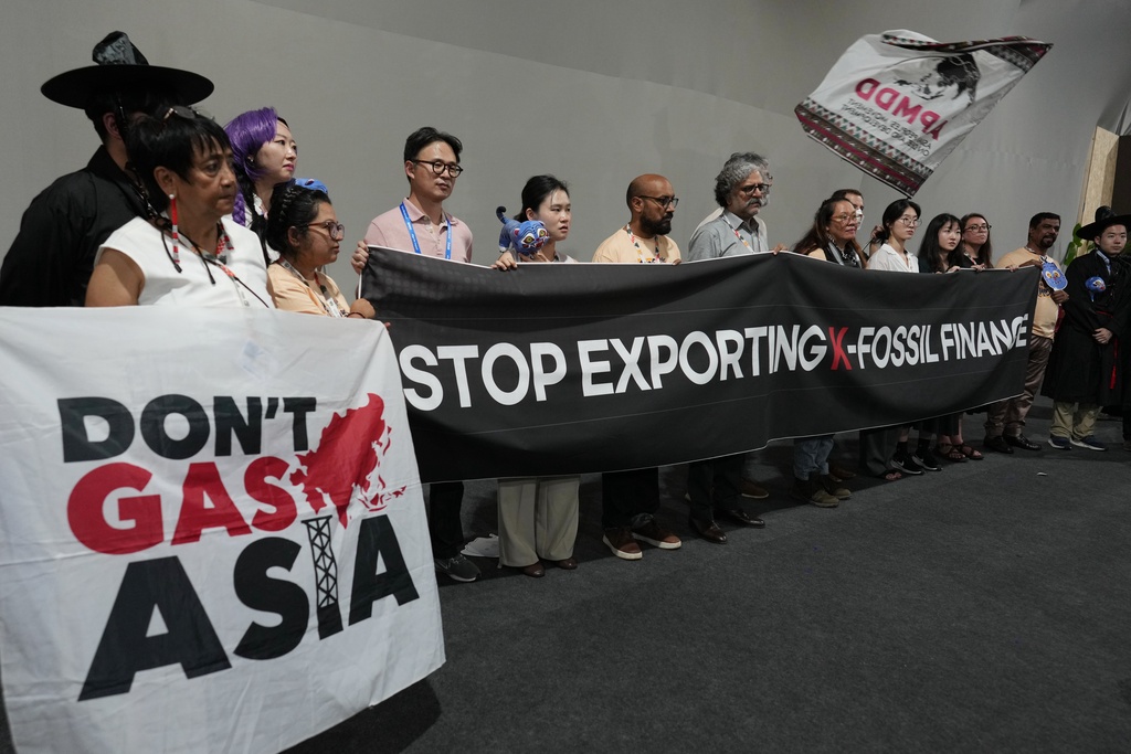 Activists participate in a demonstration calling for South Korea to stop funding fossil fuels during a Don't Gas Asia protest at the COP30 U.N. Climate Summit, Monday, Nov. 17, 2025, in Belem, Brazil. (AP Photo/Andre Penner)