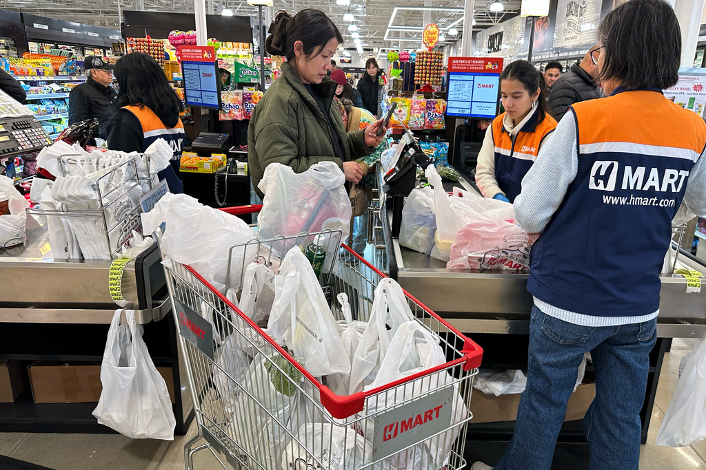 A shopper checks out at a cash register in a grocery store in Schaumburg, Ill., Monday, Feb. 9, 2026. (AP Photo/Nam Y. Huh)