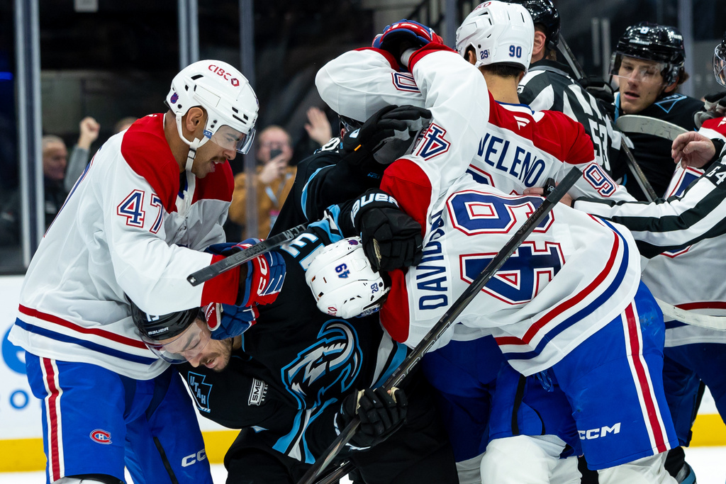Utah Mammoth left wing Brandon Tanev (13) fights with Montréal Canadiens defenseman Jayden Struble (47), center Jared Davidson (49), and center Joseph Veleno (90) during the second period of an NHL hockey game, Wednesday, Nov. 26, 2025, in Salt Lake City. (AP Photo/Anna Fuder)