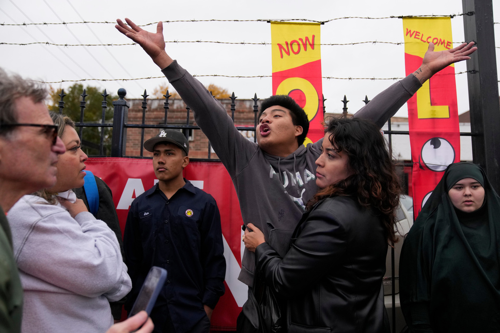 People protest the actions of federal immigration agents in Little Village, Saturday, Nov. 8, 2025, in Chicago. (AP Photo/Erin Hooley)