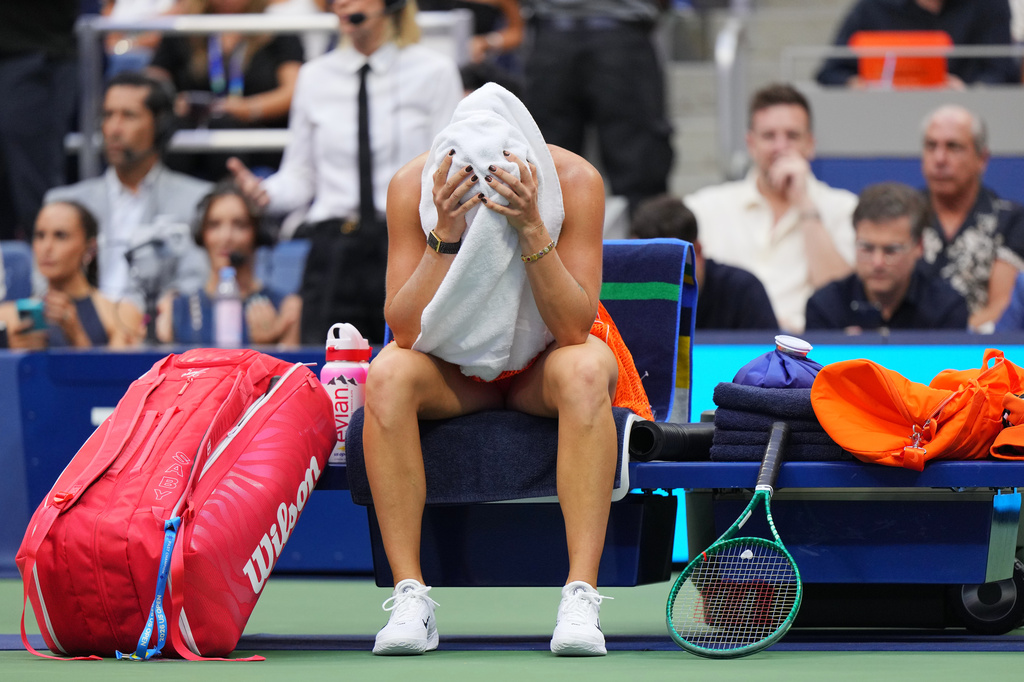 Aryna Sabalenka, of Belarus, sits with a towel on her head during a break from play during the women's singles final of the U.S. Open tennis championships against Elena Rybakina, of Kazakhstan, Saturday, Sept. 12, 2026, in New York. (AP Photo/Kirsty Wigglesworth)