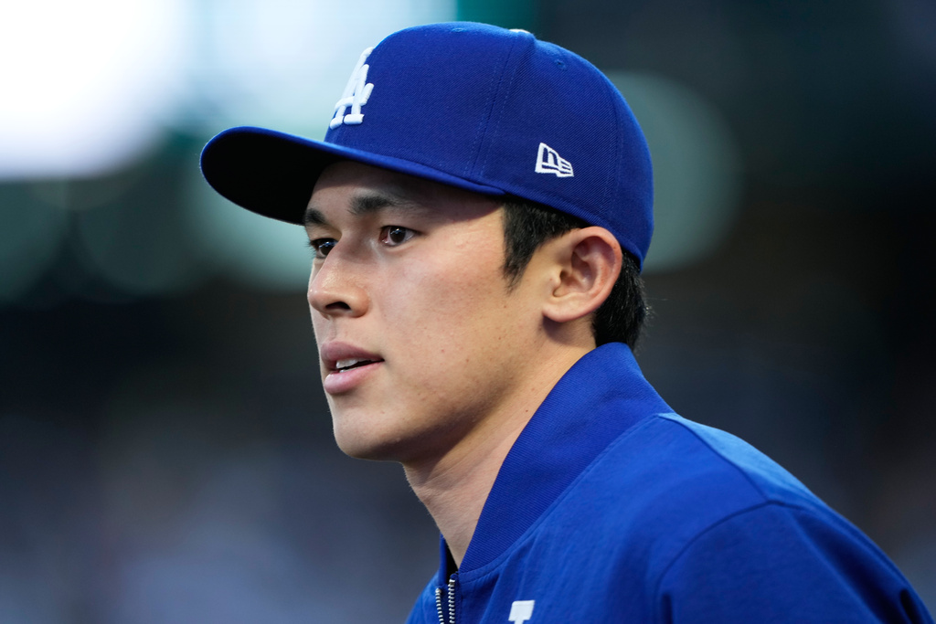 Los Angeles Dodgers starting pitcher Roki Sasaki looks on before a baseball game against the Seattle Mariners, Saturday, Sept. 27, 2025, in Seattle. (AP Photo/Ryan Sun)