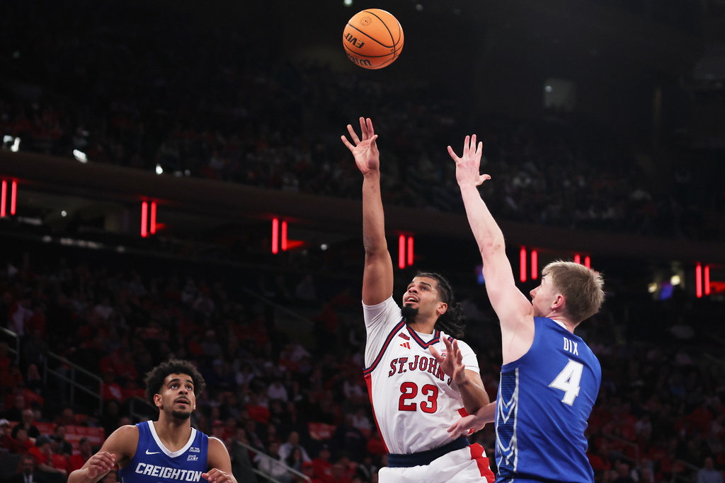 St. John's forward Bryce Hopkins (23) shoots the ball over Creighton guard Josh Dix (4) during the second half of an NCAA college basketball game, Saturday, Feb. 21, 2026, in New York. (AP Photo/Heather Khalifa)