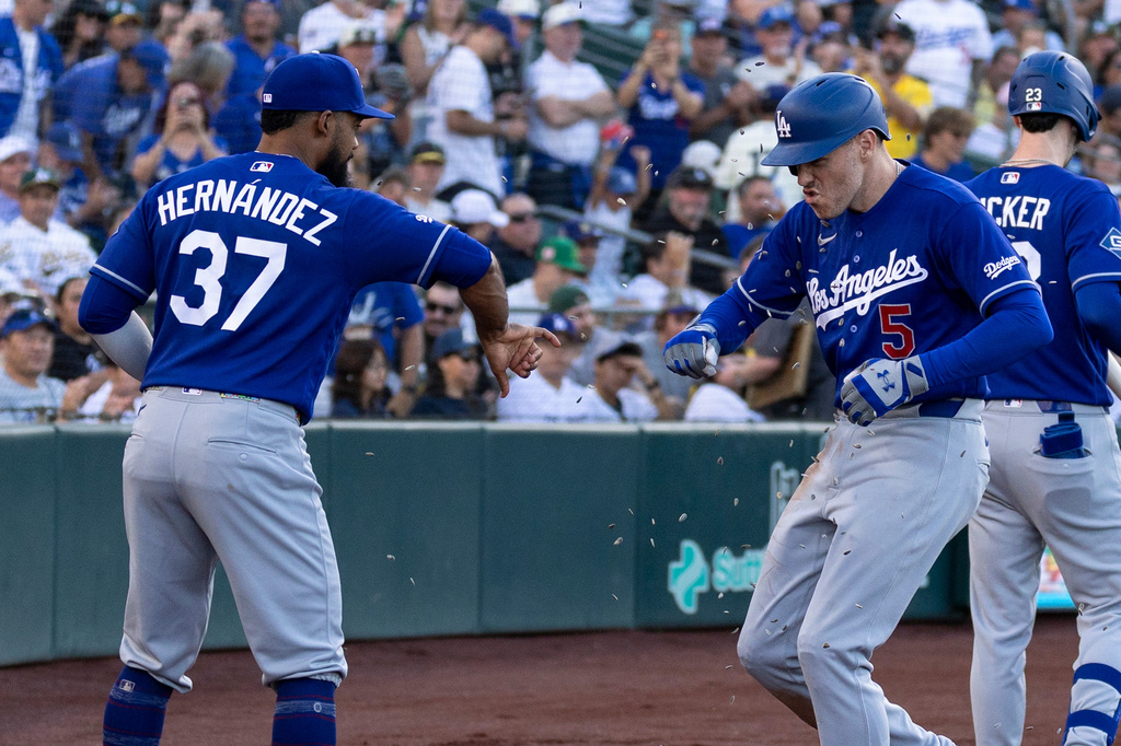 Los Angeles Dodgers' Freddie Freeman (5) celebrates with Teoscar Hernández (37) after hitting a home run during the third inning of a baseball game against the Athletics Wednesday, July 1, 2026, in West Sacramento, Calif. (AP Photo/Sara Nevis)