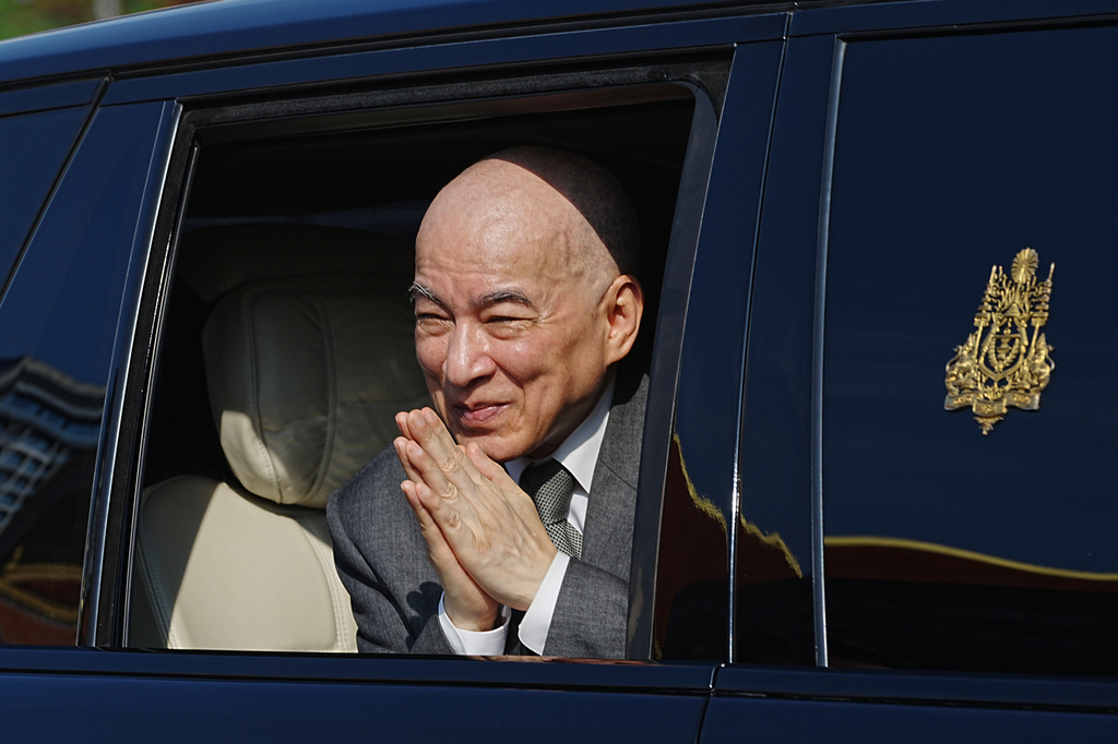 FILE -Cambodia's King Norodom Sihamoni greets from a vehicle after the King presided over the country's 72nd Independence Day ceremony at the Independence Monument in Phnom Penh Cambodia, Cambodia, Nov. 9, 2025. (AP Photo/Heng Sinith, File)