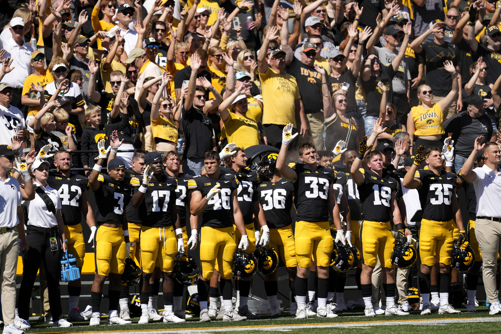 FILE - Iowa players wave to children in the University of Iowa Stead Family Children's Hospital at the end of the first quarter of an NCAA college football game against Illinois State, Aug. 31, 2024, in Iowa City, Iowa. (AP Photo/Charlie Neibergall, File)