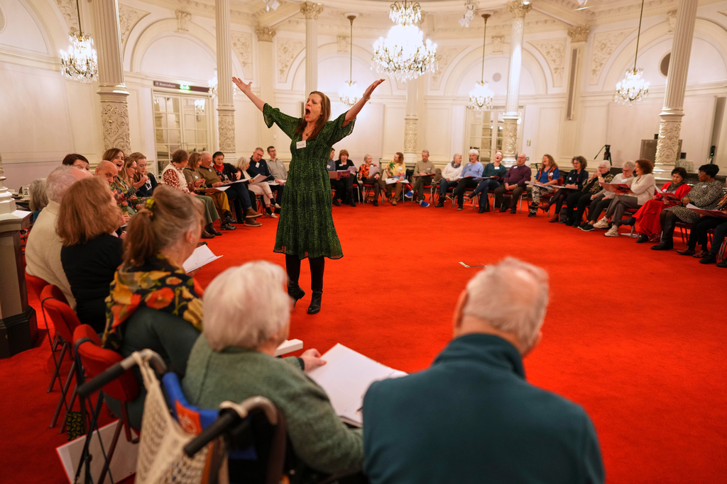 People, many of them seniors with a form of dementia, join in the "singing circle" run by opera singer Maartje de Lint, at the Concertgebouw's ornate Mirror Hall in Amsterdam on Feb. 24, 2026. (AP Photo/Peter Dejong)