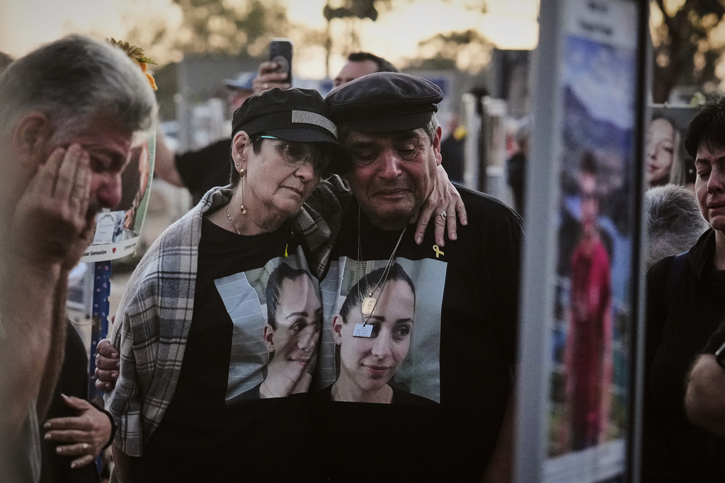 The parents of Shiran Slavin visit the site of the Nova music festival near Kibbutz Reim in southern Israel, where she and hundreds of others were killed and abducted during the deadly Hamas cross-border attack on Oct. 7, 2023, as Israel marks the second anniversary of the attack, Tuesday, Oct. 7, 2025. (AP Photo/Ariel Schalit)
