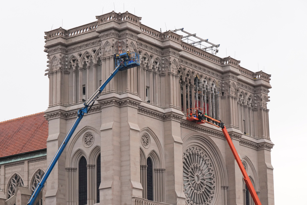 Workers install gargoyles on the Cathedral Basilica of the Assumption, Thursday, Jan. 8, 2026, in Covington, Kentucky. (AP Photo/Jeff Dean)