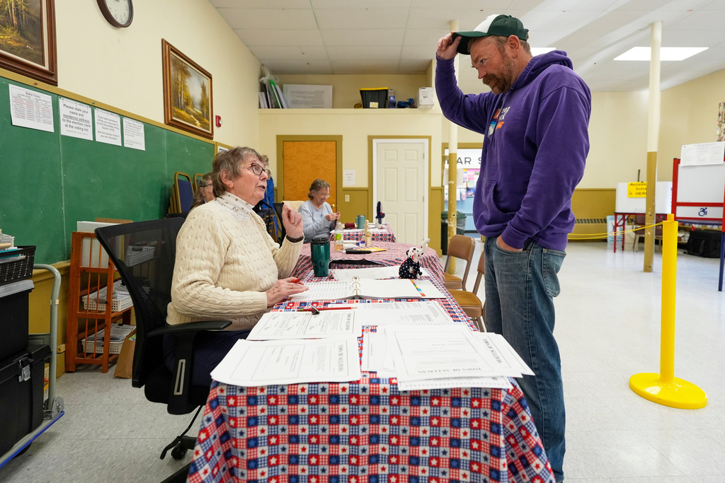 Graham Platner checks in with an election official before voting, Tuesday, Nov. 4, 2025, in Sullivan, Maine. (AP Photo/Robert F. Bukaty)