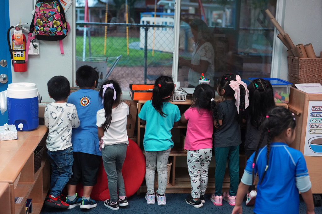 Children look out their classroom window during a thunder storm at a Head Start preschool in Immokalee, Fla., Thursday, Sept. 10, 2026. (AP Photo/Rebecca Blackwell)