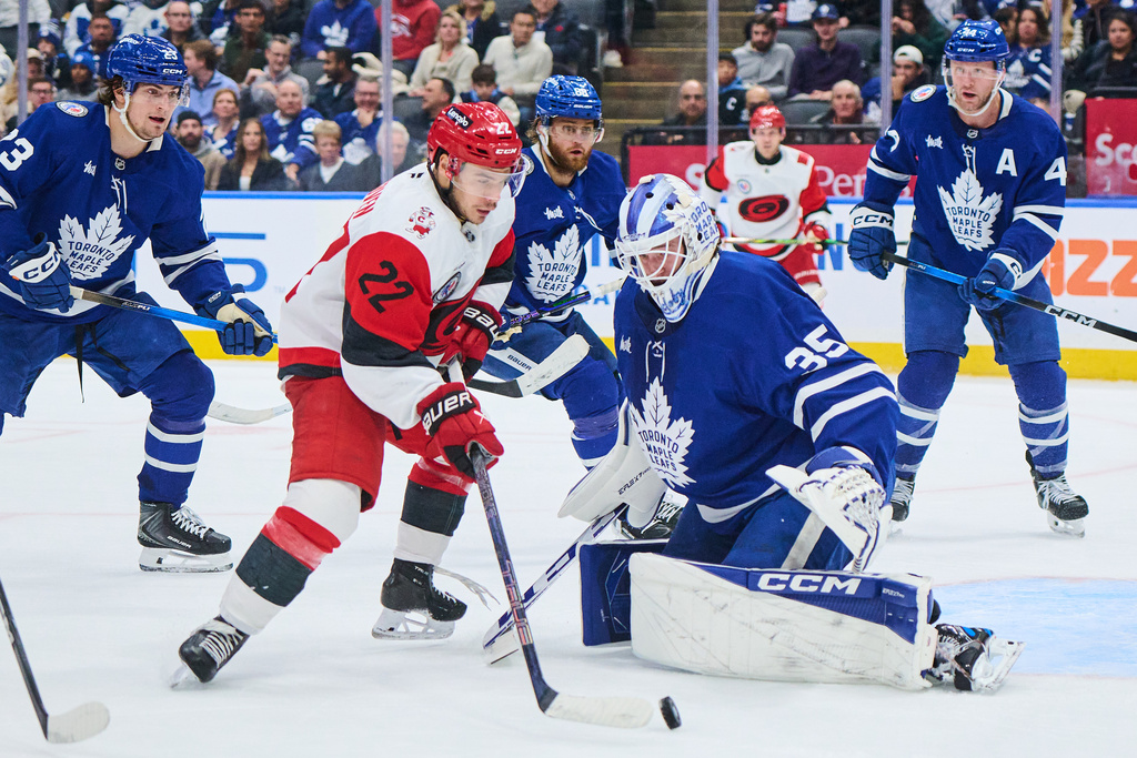 Carolina Hurricanes' Logan Stankoven (22) can't get the puck past Toronto Maple Leafs goaltender Dennis Hildeby (35) during the third period of an NHL hockey game in Toronto, on Sunday, Nov. 9, 2025. (Sammy Kogan/The Canadian Press via AP)
