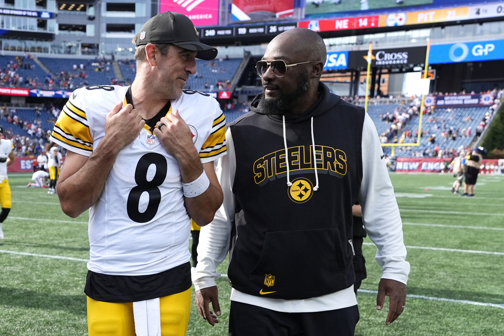 Pittsburgh Steelers quarterback Aaron Rodgers (8) and head coach Mike Tomlin leave the field after an NFL football game against the New England Patriots, Sunday, Sept. 21, 2025, in Foxborough, Mass. (AP Photo/Robert F. Bukaty)