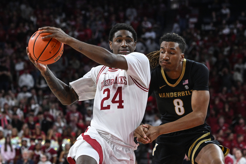 Arkansas guard Billy Richmond III (24) tries to drive past Vanderbilt guard Tyler Harris (8) during the first half of an NCAA college basketball game Tuesday, Jan. 20, 2026, in Fayetteville, Ark. (AP Photo/Michael Woods)
