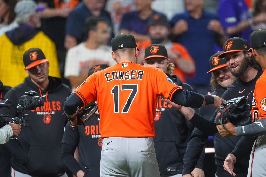 Baltimore Orioles center fielder Colton Cowser is congratulated by teammates after the Orioles' victory over the Colorado Rockies in a baseball game Monday, Aug. 31, 2026, in Denver. (AP Photo/David Zalubowski)