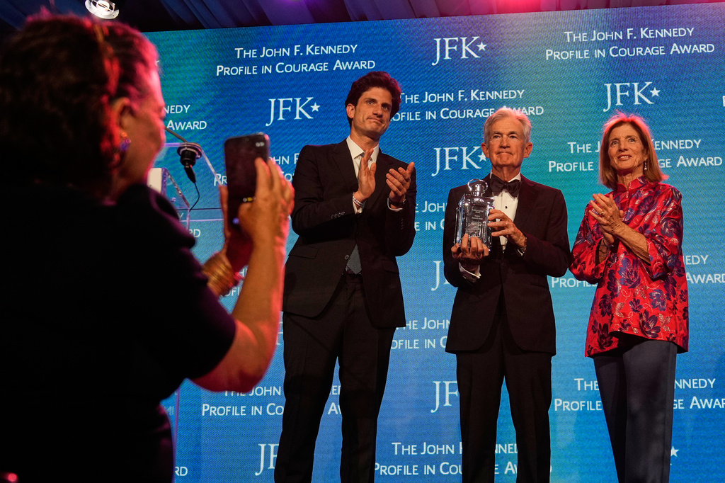 Federal Reserve Board Governor Jerome Powell, the former Federal Reserve chair, center, stands with former ambassador Caroline Kennedy, right, and her son Jack Schlossberg, as Powell's wife Elissa Leonard takes a picture at left, while being honored with the Profile in Courage Award at the John F. Kennedy Presidential Library, Sunday, May 31, 2026, in Boston. (AP Photo/Charles Krupa)