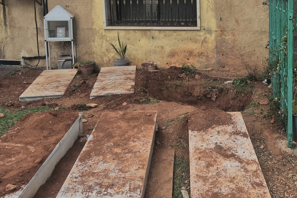 A grave, background, dug by Israeli forces landed overnight late Friday, searching for Israeli co-pilot Ron Arad who was captured and then went missing after his fighter jet crashed over south Lebanon in 1986, in Nabi Chit village, eastern Lebanon, Saturday, March 7, 2026. (AP Photo/Ali Salem)