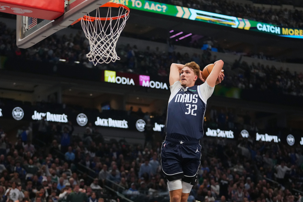 Dallas Mavericks forward Cooper Flagg dunks on the Philadelphia 76ers during the first half of an NBA basketball game Thursday, Jan. 1, 2026, in Dallas. (AP Photo/Julio Cortez)