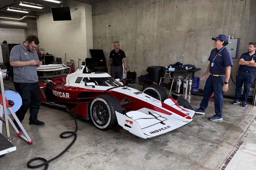 Officials from chassis manufacturer Dallara work on the new IndyCar model, Sunday, Aug. 2, 2026, at Indianapolis Motor Speedway in Indianapolis. (AP Photo/Mike Marot)