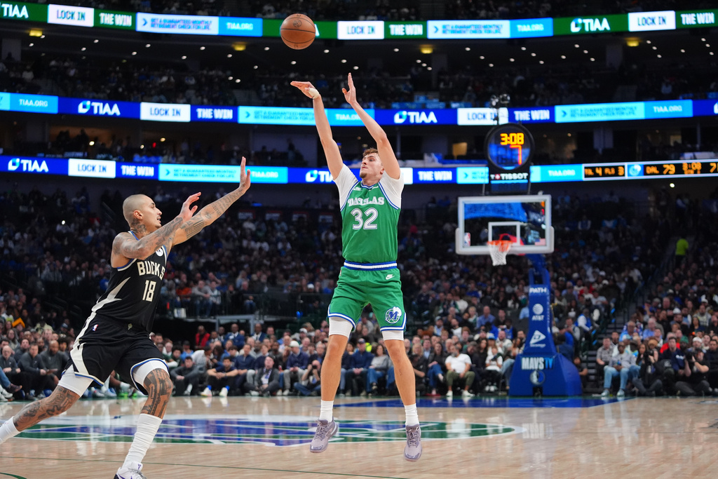 Dallas Mavericks forward Cooper Flagg (32) shoots against Milwaukee Bucks forward Kyle Kuzma (18) during the second half of an NBA basketball game in Dallas, Monday, Nov. 10, 2025. (AP Photo/LM Otero)