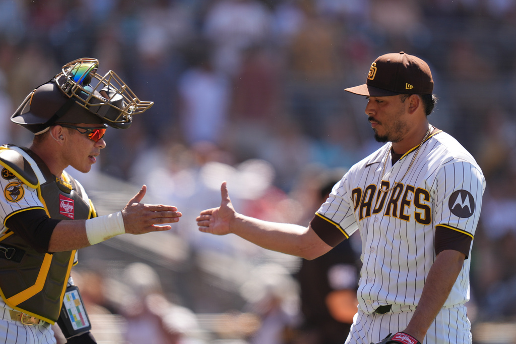 San Diego Padres pitcher Jeremiah Estrada is greeted by catcher Freddy Fermin after the third out during the eighth inning of a baseball game against the Colorado Rockies Wednesday, July 29, 2026, in San Diego. (AP Photo/Gregory Bull)