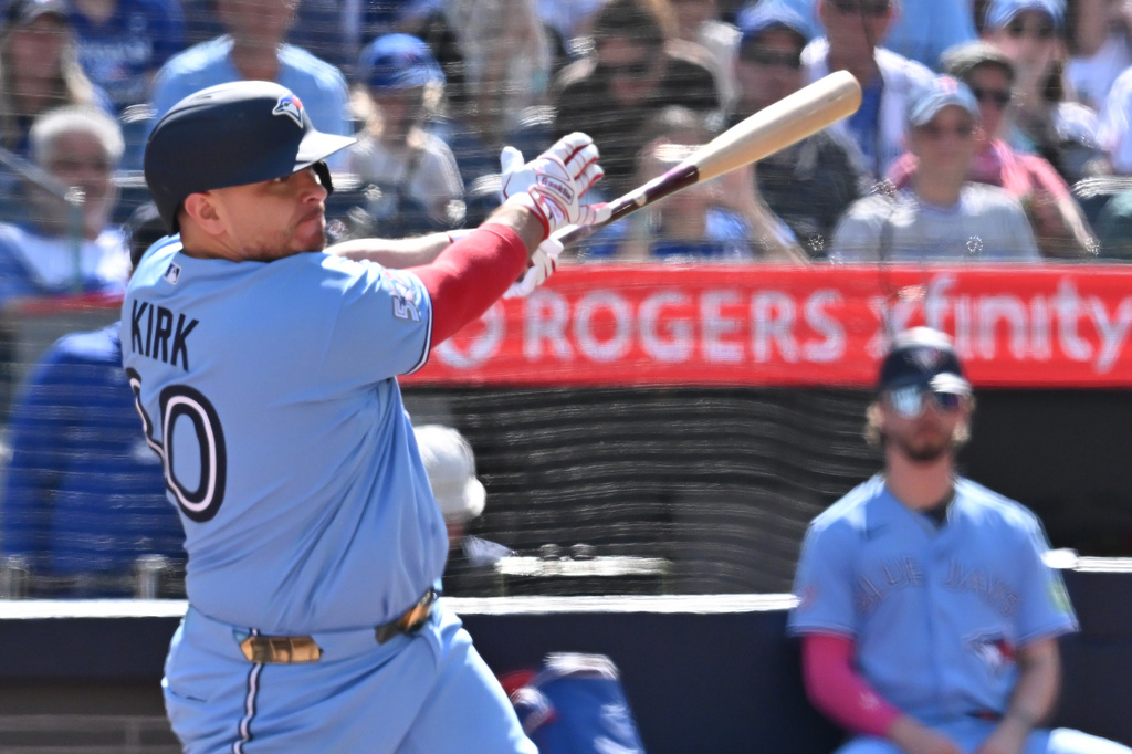 Toronto Blue Jays catcher Alejandro Kirk (30) hits an RBI single against the New York Yankees during the third inning of a baseball game in Toronto, Saturday, Aug. 15, 2026. (Jon Blacker/The Canadian Press via AP)