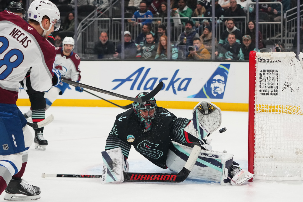 Colorado Avalanche center Martin Necas (88) scores against Seattle Kraken goaltender Joey Daccord (35) during the first period of an NHL hockey game Thursday, March 12, 2026, in Seattle. (AP Photo/Lindsey Wasson)