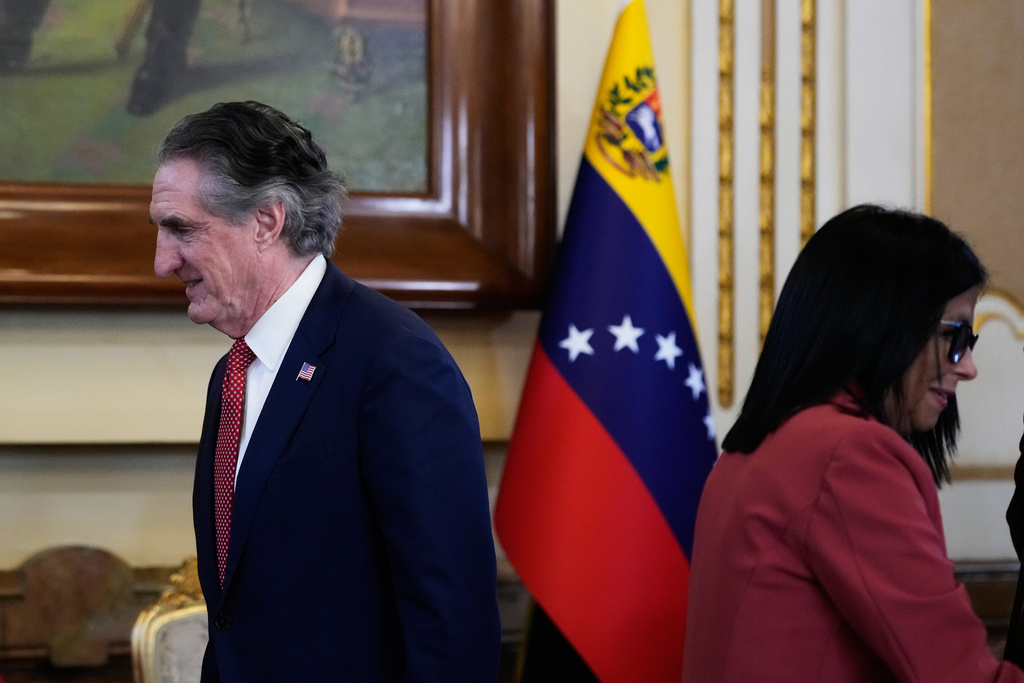 Venezuela's acting President Delcy Rodriguez, right, and U.S. Interior Secretary Doug Burgum arrive for a meeting at Miraflores presidential palace in Caracas, Venezuela, Wednesday, March 4, 2026. (AP Photo/Ariana Cubillos)