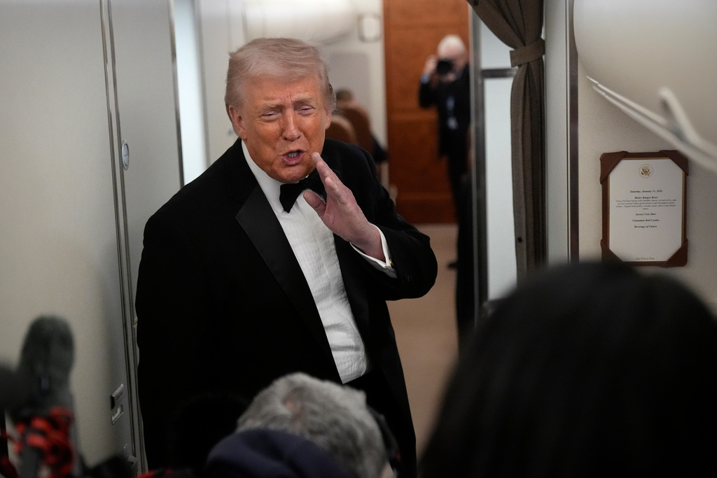 President Donald Trump speaks with reporters aboard Air Force One as he travels from Joint Base Andrews, Md. to West Palm Beach, Fla., Saturday, Jan. 31, 2026. (AP Photo/Mark Schiefelbein)