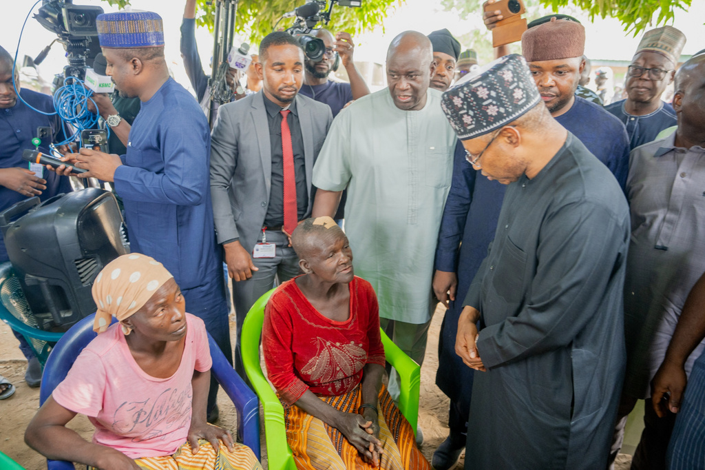 In this photo released by the Kaduna State government, Governor. Uba Sani, right, visits people that were attacked by gunmen and abducted many in Kurmin Wali, northwest Nigeria, Wednesday, Jan. 21, 2026. (Kaduna State Government via AP)