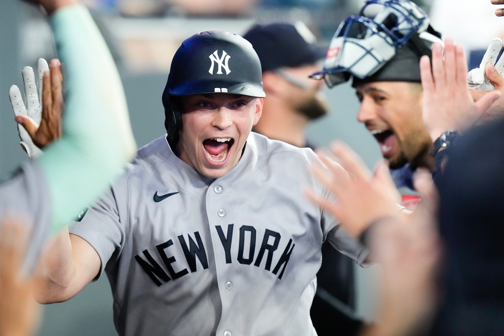 New York Yankees' Ben Rice, center, celebrates in the dugout after hitting a two-run home run during the ninth inning of a baseball game against the Toronto Blue Jays in Toronto, Sunday, June 14, 2026. (Chris Young/The Canadian Press via AP)