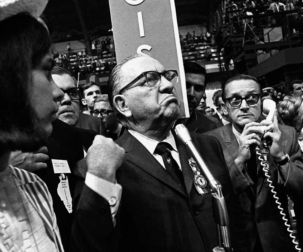 FILE - Mayor Richard J. Daley stands at the microphone as shouts resound through the International Amphitheater in Chicago, demanding the Democratic National Convention adjourn until later in the day before considering the party platform, Aug. 28, 1968. During the convention, hundreds of demonstrators waged war with police and National Guardsmen on the streets of Chicago. (AP Photo/Jack Thornell, File)