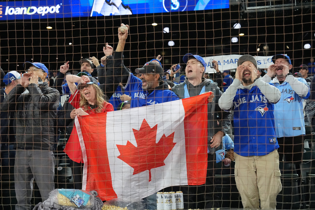 Toronto Blue Jays fans celebrate after the Blue Jays defeated the Seattle Mariners in Game 3 of baseball's American League Championship Series, Wednesday, Oct. 15, 2025, in Seattle. (Frank Gunn/The Canadian Press via AP)