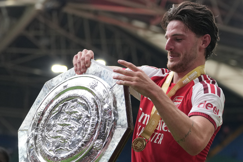 Arsenal's Declan Rice holds the trophy after his team won the FA Community Shield final soccer match between Arsenal and Manchester City in Cardiff, Wales, Sunday, Aug.16, 2026. (AP Photo/Alastair Grant)