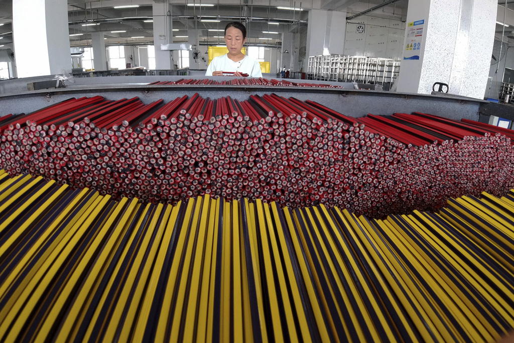 An employee works at a factory producing pencils in Binzhou in eastern China's Shandong province on Thursday, Aug. 21, 2025. (Chinatopix via AP)