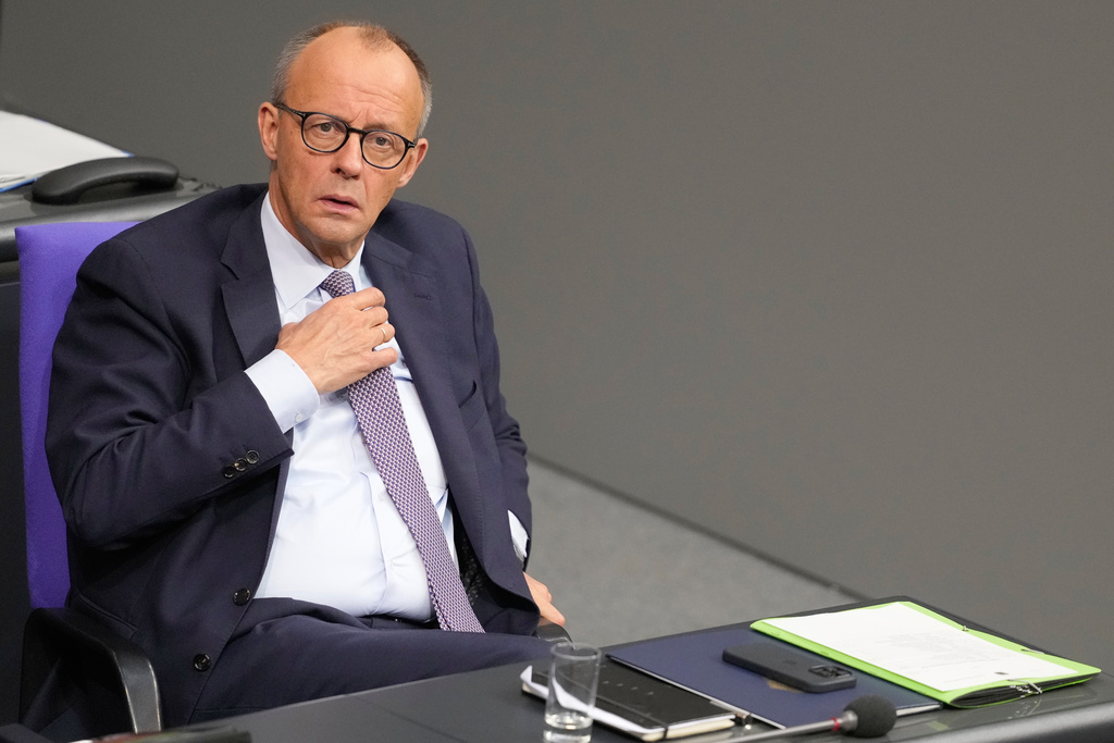 German Chancellor Friedrich Merz sits on his place after he addressed the German parliament during a debate at the Reichstag in Berlin, Germany, Thursday, Oct. 16, 2025. (AP Photo/Markus Schreiber)