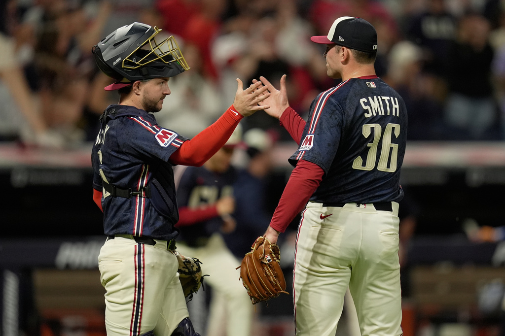 Cleveland Guardians catcher Patrick Bailey, left, congratulates pitcher Cade Smith (36) after the Guardians defeated the Boston Red Sox in a baseball game in Cleveland, Friday, May 29, 2026. (AP Photo/Sue Ogrocki)