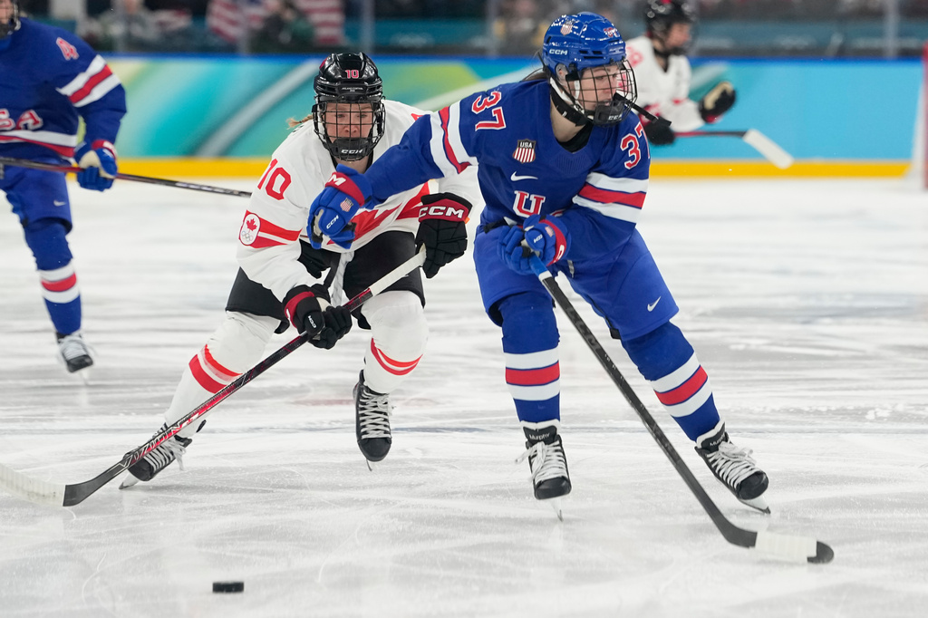 FILE - United States' Abbey Murphy (37) challenges with Canada's Sarah Fillier (10) during a women's ice hockey gold medal game between the United States and Canada at the 2026 Winter Olympics, in Milan, Italy, Feb. 19, 2026. (AP Photo/Hassan Ammar, File)