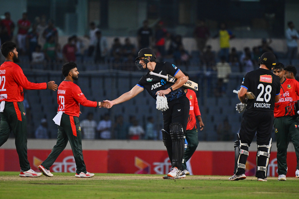 New Zealand's Bevon Jacobs shakes hands with Bangladesh's players after winning the third T20 international cricket match between Bangladesh and New Zealand in Mirpur, Bangladesh, Saturday, May 2, 2026. (AP Photo/Mosaraf Hossain)