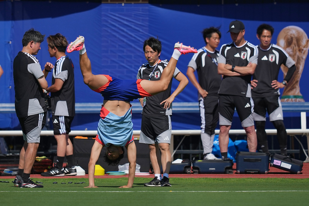 Japan's Yukinari Sugawara does a cartwheel before the start of a training session ahead of his team's FIFA World Cup soccer tournament Group F match against the Netherlands, Saturday, June 13, 2026, in Dallas. (AP Photo/Julio Cortez)