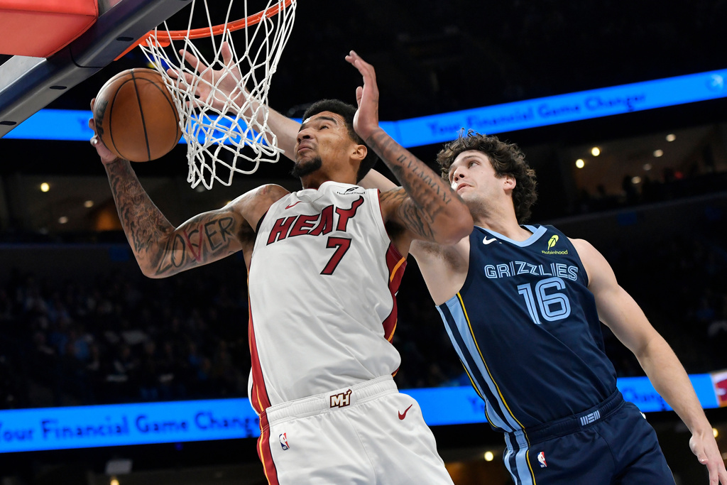 Miami Heat center Kel'el Ware (7) grabs a rebound ahead of Memphis Grizzlies center PJ Hall (16) in the first half of an NBA basketball game Friday, Oct. 24, 2025, in Memphis, Tenn. (AP Photo/Brandon Dill)
