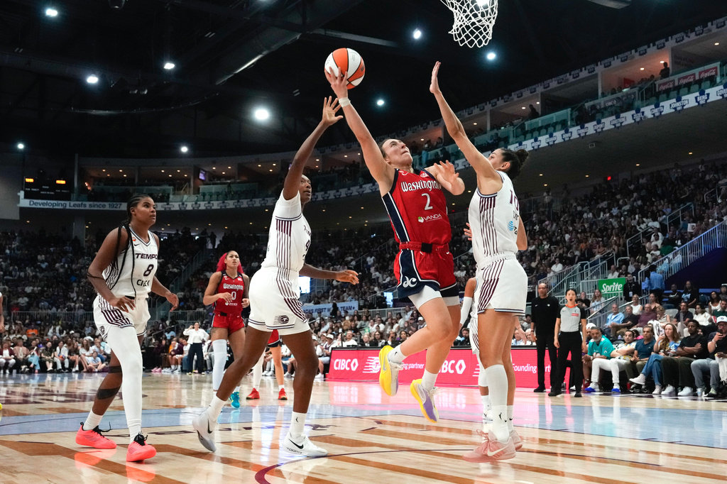 Washington Mystics' Nyla Harris (2) shoots on Toronto Tempo's Marie Conde during the second half of a WNBA basketball game in Toronto, Tuesday, July 14, 2026. (Chris Young/The Canadian Press via AP)