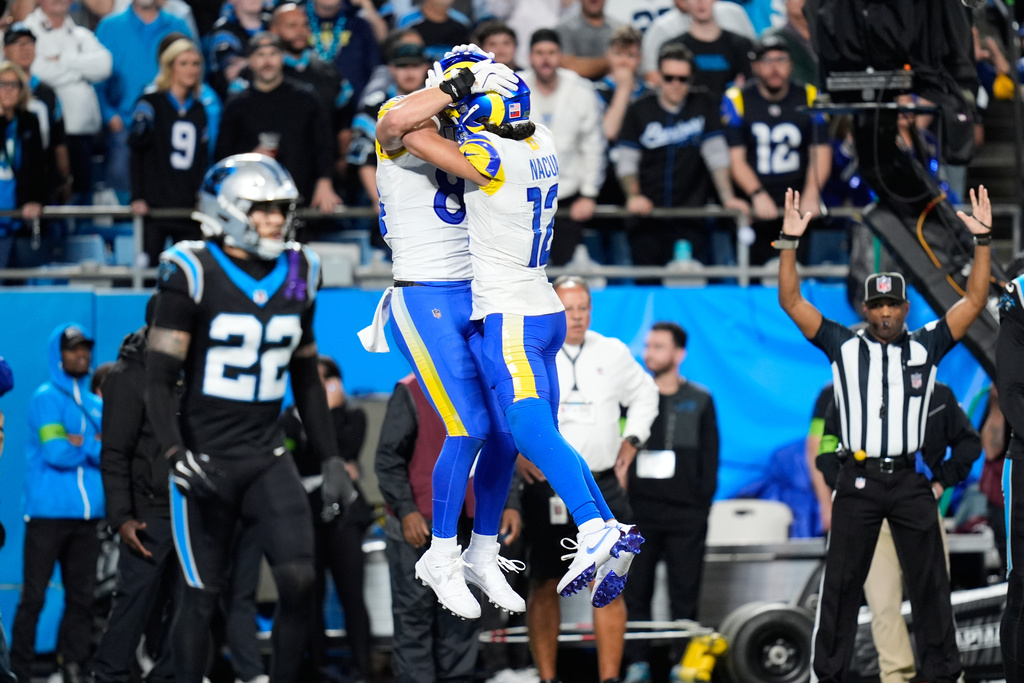 Los Angeles Rams tight end Colby Parkinson, center left, celebrates his touchdown catch with wide receiver Puka Nacua (12) during the second half of an NFL wild-card playoff football game against the Carolina Panthers, Saturday, Jan. 10, 2026, in Charlotte, N.C. (AP Photo/Erik Verduzco)