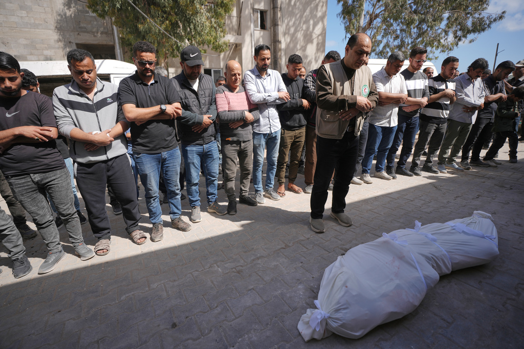 Palestinians pray over the body of a person killed in Israeli airstrikes Friday targeting Izz al-Din al-Haddad, the leader of Hamas’ Qassam Brigades, during a funeral outside Shifa Hospital in Gaza City, Saturday, May 16, 2026. (AP Photo/Jehad Alshrafi)