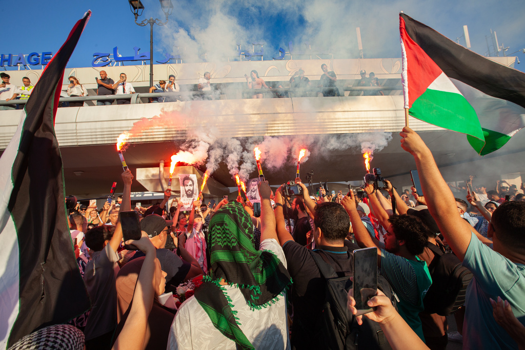People welcome a number of activists who took part in the Global Sumud Flotilla that attempted to sail to Gaza after they were released from Israeli prison, at Tunis–Carthage International Airport, Sunday, Oct. 5, 2025, in Tunis, Tunisia. (AP Photo/Ons Abid)
