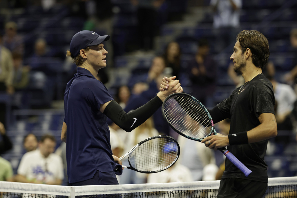 Jannik Sinner, left, of Italy, shakes hands with Lorenzo Musetti, of Italy, after defeating him during the quarterfinal round of the U.S. Open tennis championships, Wednesday, Sept. 3, 2025, in New York. (AP Photo/Adam Hunger)