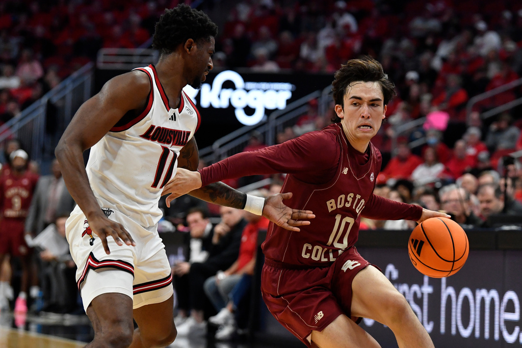 Boston College guard Luka Toews (10) attempts to drive past Louisville guard Kobe Rodgers (11) during the first half of an NCAA college basketball game in Louisville, Ky., Saturday, Jan. 10, 2026. (AP Photo/Timothy D. Easley)