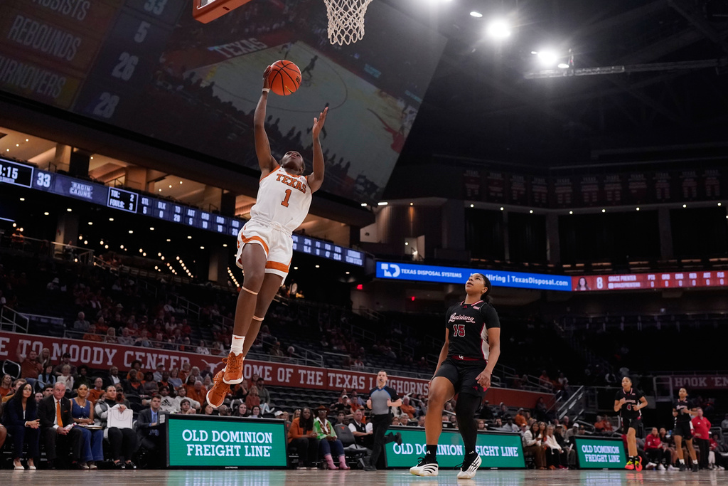 Texas guard Bryanna Preston (1) scores past Louisiana Lafayette guard Imani Daniel (15) during the second half of an NCAA college basketball game in Austin, Texas, Monday, Nov. 10, 2025. (AP Photo/Eric Gay)